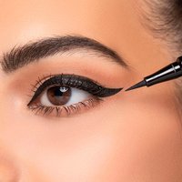 Black Artdeco eyeliner pen with fine tip, applying precise line on eyelid for bold, long-lasting look.
