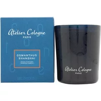 Atelier Cologne Osmanthus Shanghai Candle, 180g, in dark glass jar with blue box featuring white and gold text.