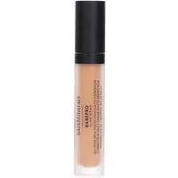 BareMinerals matte concealer stick with black cap, clear tube showing medium neutral shade, SPF 20 label.