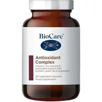 Brown BioCare Antioxidant Complex bottle with white label, blue logo, and text detailing vitamin C and turmeric benefits.