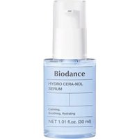 Clear bottle of Biodance Hydra Cera-Nol Serum, 30 ml, with white pump and blue liquid inside.