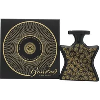 Black star-shaped Bond No 9 Wall Street perfume bottle with gold emblem pattern, next to matching black box.