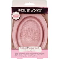 Pink oval silicone makeup brush cleaning bowl with textured surface in branded packaging.