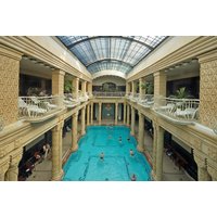 Budapest city break package with central hotel, breakfast, return flights, features ornate indoor pool with skylight.