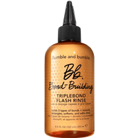 Amber bottle of Bumble and Bumble Bond Building Triplebond Flash Rinse with black nozzle and bold black text.