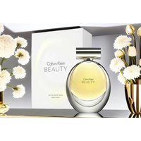 Calvin Klein Beauty Eau de Parfum 50ml bottle with silver cap, set against a white box and surrounded by white flowers.