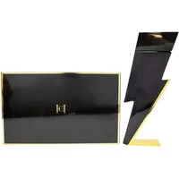 Black lightning bolt-shaped Carolina Herrera Bad Boy Eau De Toilette bottle with gold accents, next to black box.