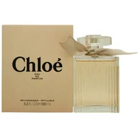 Chloé Signature Eau De Parfum 100ml, clear ribbed glass bottle with beige ribbon, next to beige box with black text.