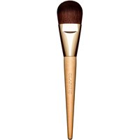 Gold Clarins Foundation Brush with a tapered wooden handle and dense, rounded bristles.