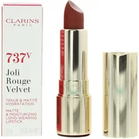 Gold Clarins lipstick tube with a deep red shade, labeled 737v Spicy Cinnamon, next to matching white and red box.