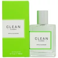 Clear glass bottle of CLEAN Apple Blossom Eau De Parfum with silver cap, next to bright green box.