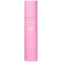Pink bottle of Cocoa Brown Sunshine Serum, labeled "Medium," with white text and logo.