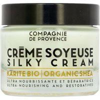 Compagnie De Provence Face Cream jar with black lid, labeled "Crème Soyeuse Silky Cream Organic Shea" in black text.