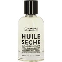 Clear bottle of Compagnie De Provence Ultra Nourishing Dry Oil with black cap and bold black text on the label.