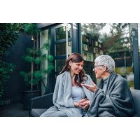 CPD-Certified Dementia Awareness Online Course by Coursegate, featuring two women in conversation, wrapped in blankets.