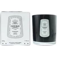 Black Creed Vanisia candle in glass holder with white label, next to matching white box with black text and logo.