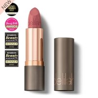Delilah Colour Intense Cream Lipstick in Sienna, rose gold and taupe tube, awards displayed beside.