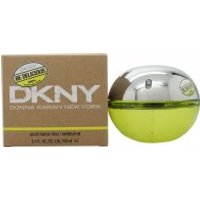 Round DKNY Be Delicious perfume bottle with silver top and green base, next to brown box with white branding.