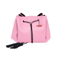 Pink faux leather makeup bag with black drawstring, tassels, and red lips pin by Donna May London.