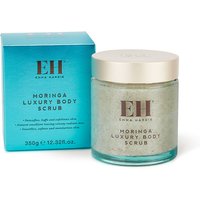 Emma Hardie Moringa Luxury Body Scrub in clear jar with gold lid, next to teal box with brand logo.