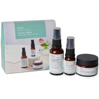 Evolve Organic Beauty set with amber bottles, white labels, spray tops, and a jar, in front of a branded box.