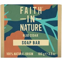 Faith in Nature Blue Cedar Soap Bar, 100g, with bold text on a green and blue abstract background.