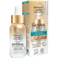 Garnier Ambre Solaire Natural Bronzer Face Drops, 30 ml bottle with gold cap, next to matching box.