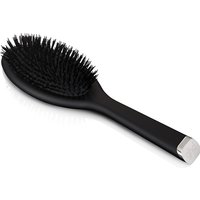Black oval hair brush by GHD with soft bristles and sleek handle, featuring a silver end cap.