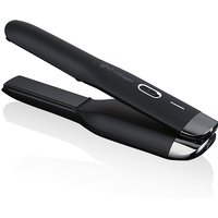 Black ghd Unplugged cordless styler with sleek design, silver accents, and LED indicator.