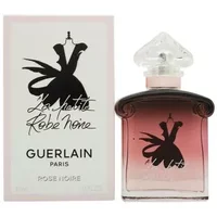 Pink gradient Guerlain perfume bottle with a clear, heart-shaped cap, next to matching box with black dress design.