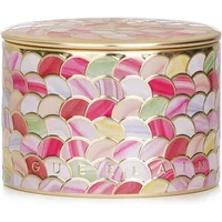 Guerlain Meteorites powder in a round, colorful mosaic tin with pink, green, and gold scallop design.