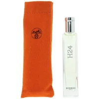 Clear glass Hermès H24 Eau De Toilette 15ml bottle with silver cap, next to orange fabric pouch.