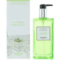 Hermès Un Jardin Sur Le Toit shower gel, green bottle with black pump, next to matching box.