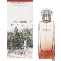 Clear glass bottle with gradient amber hue, silver cap, and box featuring garden illustration, Hermes Un Jardin Sur La Lagune 100ml.