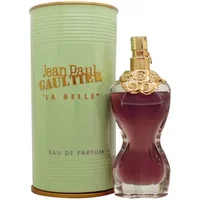Curvy red perfume bottle with gold floral neck, next to light green cylindrical box labeled "Jean Paul Gaultier La Belle".