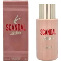 Pink Jean Paul Gaultier Scandal body lotion bottle with gold cap and matching box featuring logo and leg graphic.