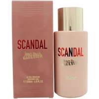 Pink Jean Paul Gaultier Scandal shower gel bottle with gold cap, next to matching pink box with red and gold text.