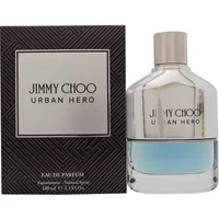 Jimmy Choo Urban Hero Eau De Parfum 100ml bottle with silver cap and blue tint, next to black patterned box.
