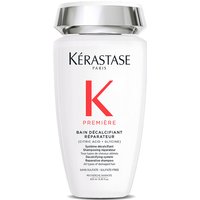 White Kérastase shampoo bottle with silver cap, red "K" logo, and black text detailing product name and features.