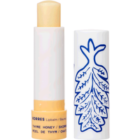 Korres Honey & Thyme Lip Balm 4.5g, white tube with blue leaf design, beige balm stick.