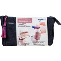 Korres Skincare Expert Set in dark pouch with pink tassel, featuring Wild Rose products and brightening details on label.