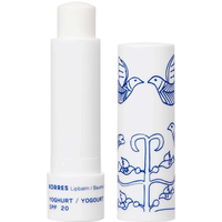 White Korres Yoghurt Lip Balm with blue bird design, SPF20, 4.5g, cap off showing balm stick.