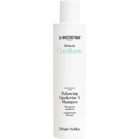 White cylindrical bottle of La Biosthetique Balancing Lipokerine A Shampoo, 250ml, with black and green text.