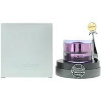 La Prairie eye cream in a purple jar with silver lid, on a black base, next to a light grey box.