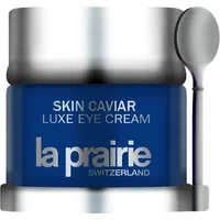 Blue jar of La Prairie Skin Caviar Luxe Eye Cream with silver lid and small applicator spoon.