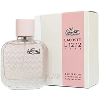 Transparent square glass bottle with pink cap, Lacoste logo, next to pink and white box, "L.12.12 Rose" text.