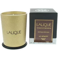 Gold Lalique candle in a matching holder, black base, with a black and gold box labeled "Le Desert Muscat Oman 190g".