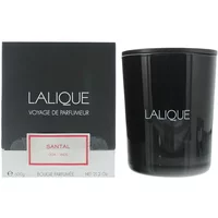 Black Lalique Santal Goa India candle in glass holder beside matching black box with white and red label.