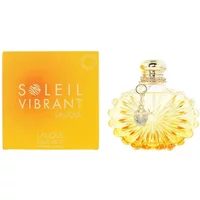 Lalique Soleil Vibrant Eau De Parfum 100ml in a sunburst-shaped bottle with a gold cap, next to a yellow box.