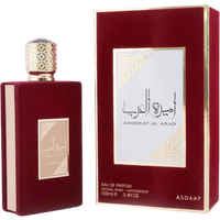 Red rectangular perfume bottle with gold cap and label, next to matching box with gold Arabic script and design.